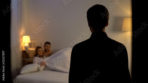 Leinwand Poster Man looking at his wife with lover in bed, unfair relations, partner cheating