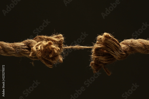 closeup.old frayed rope .isolated on a black background.