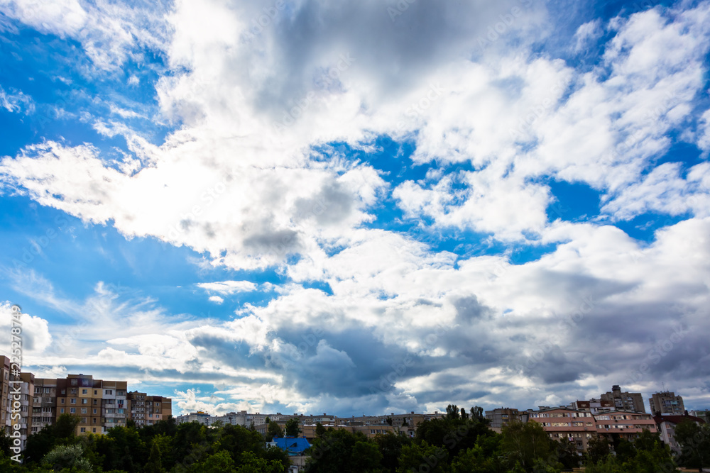 old apartment buildings on blue sky background with clouds
