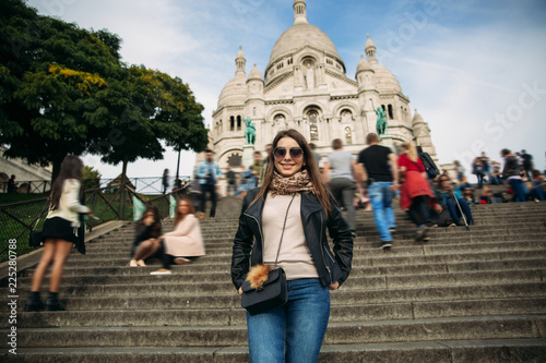 Beautiful girl is walkin in paris near the basilica