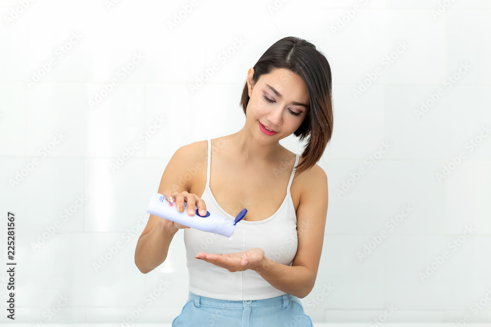 Beautiful young woman in underwear applying body lotion. Beautiful young woman in underwear applying body lotion.