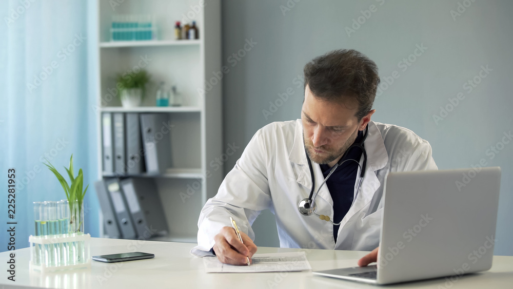 Doctor viewing test results on laptop and writing down medical records, medicine