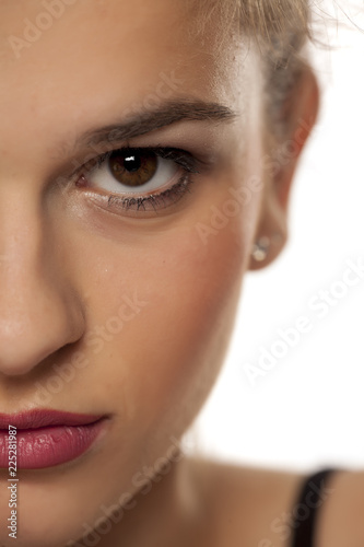 Half portrait of young beautiful woman with makeup on white background