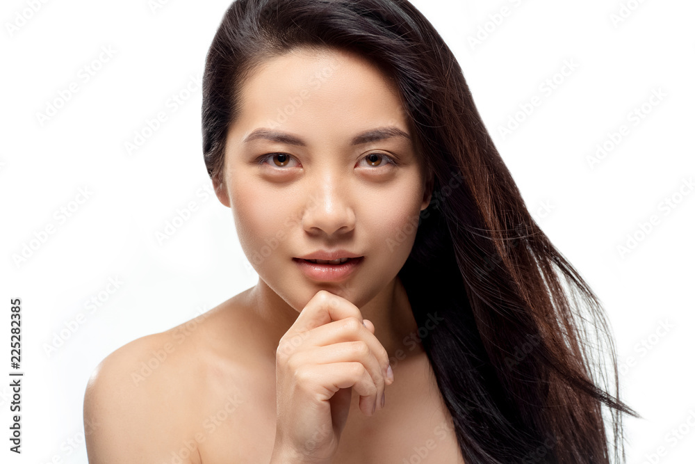 portrait of attractive asian model with strong and healthy hair looking at camera isolated on white portrait of attractive asian model with strong and healthy hair looking at camera isolated on white