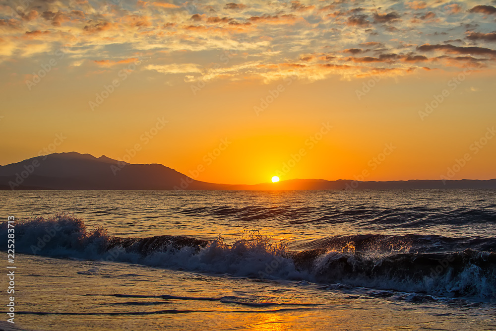 Naklejka premium Early morning , dramatic sunrise over sea and mountain. Photographed in Asprovalta, Greece.
