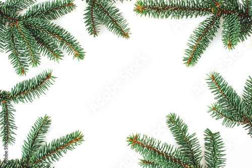 Christmas composition. Green fir  spruce tree branches border isolated on white table backhround. Flat lay  top view  empty space.