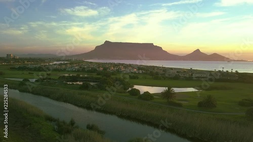 Fly towards Table Mountain over river and wetlands