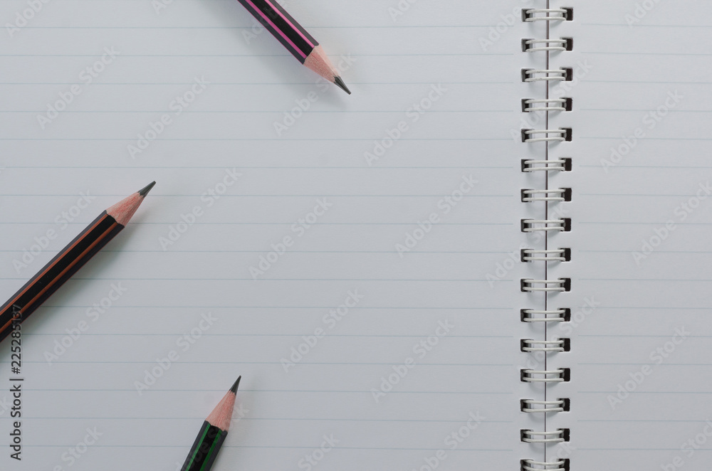 Wirebound Notebook Open with Lined Paper and Pencils. Wirebound Notebook Open with Lined Paper and Pencils.