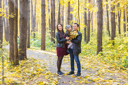 People  family and leisure concept - family having fun standing in autumn park