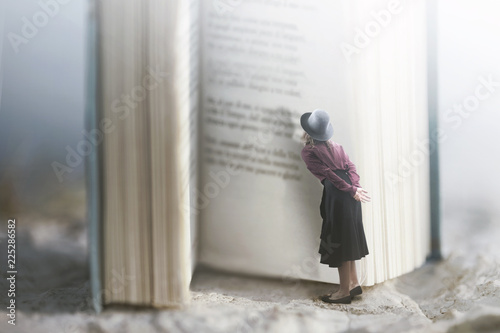 Curious woman reads a giant book photo