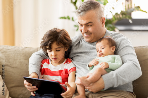 family, fatherhood and people concept - happy father with preteen and baby son at home