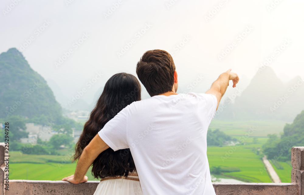 Couple enjoying Karst mountain view together Couple enjoying Karst mountain view together