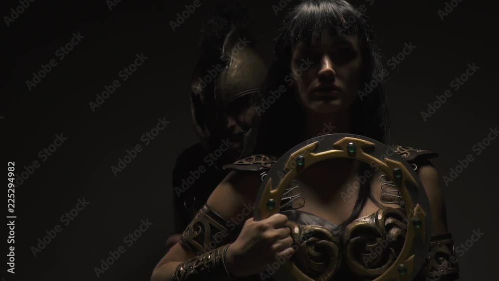 Pathos Amazon stands with a battle disk, the Roman legionary approaches her and lies on the shoulder Pathos Amazon stands with a battle disk, the Roman legionary approaches her and lies on the shoulder