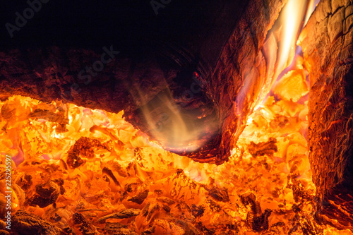 Red hot coals burning in the fireplace, close-up, burning firewood