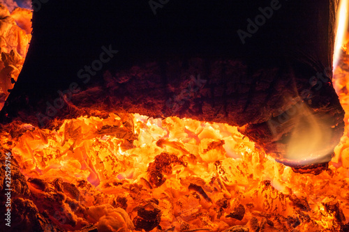 Red hot coals burning in the fireplace, close-up, burning firewood, heat