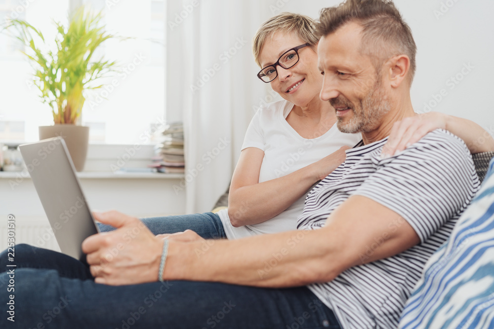 Middle aged couple using laptop at home Middle aged couple using laptop at home