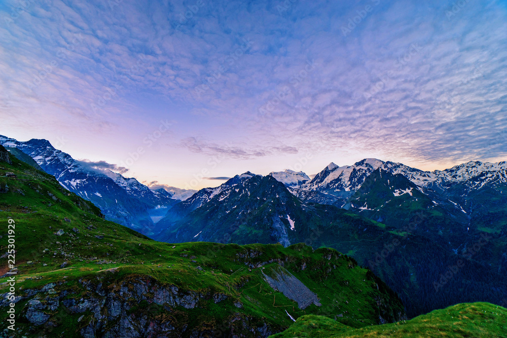 Scenic view of beautiful Swiss Alps mountains. Blue hour sunrise with pink and blue tones, Verbier, Canton du Valais, Wallis, Switzerland.