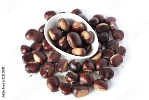 pile of chestnuts in a white bowl isolated
