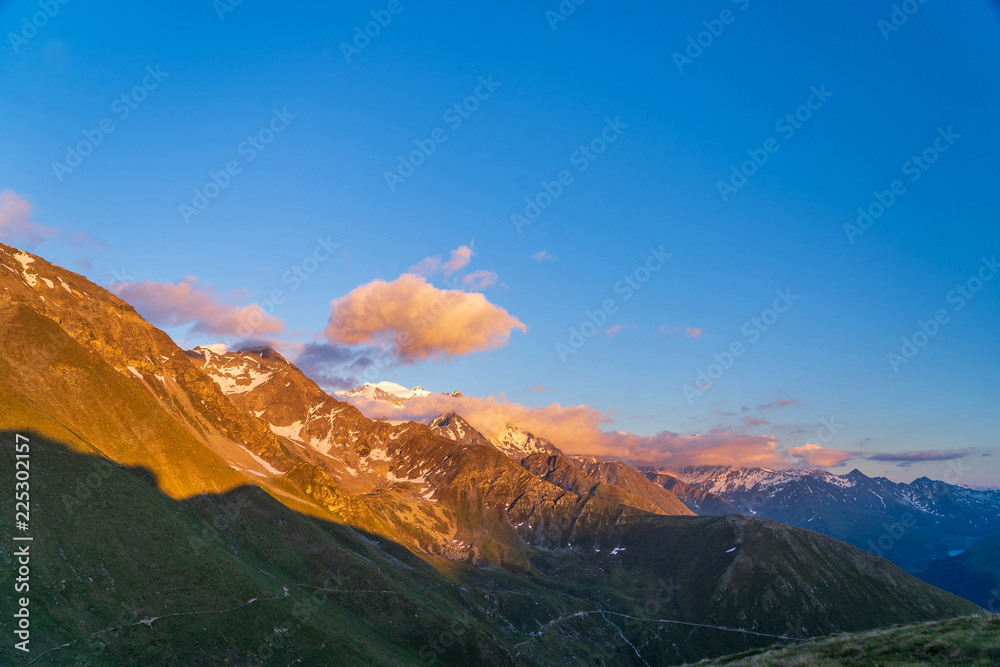 Obraz premium Scenic view of beautiful landscape of Swiss Alps in a Val De Bagnes area. Clouds covering high peaks of Valais Alps (Pennine Alps), Switzerland.