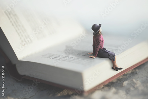 surreal moment of a woman relaxes sitting on a giant book