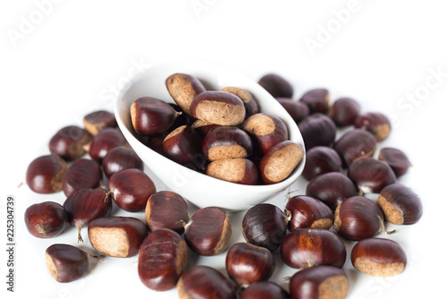 pile of chestnuts in a white bowl isolated 