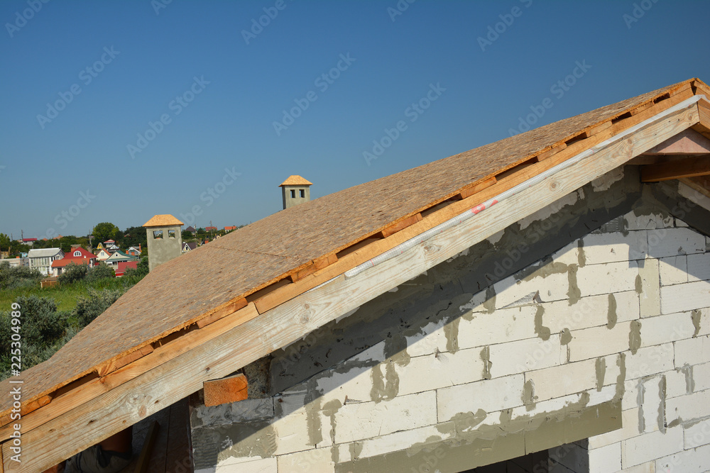 Roofing construction with trusses, wooden beams on new house building. Rooftop view. Roofing construction with trusses, wooden beams on new house building. Rooftop view.