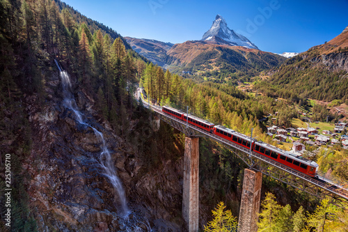 Zermatt, Switzerland. Image of Swiss Alps with Gornergrad tourist train, waterfall and Matterhorn in Valais region.