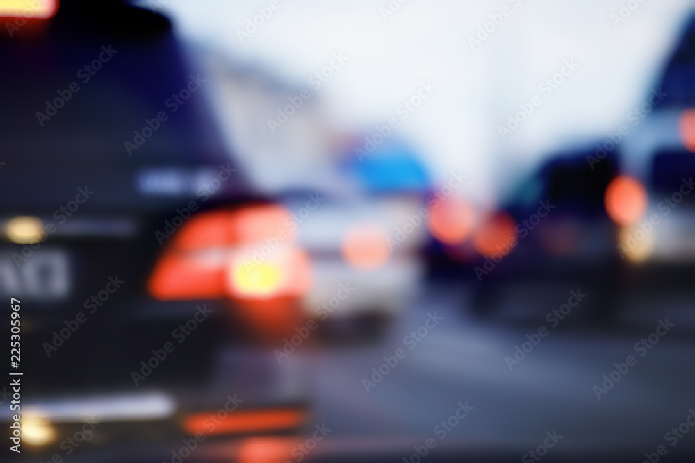 view of car in  traffic jam / rear view of the landscape from window in car, road with cars, lights and the legs of the cars  night view