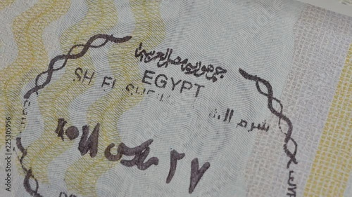 Egypt passport stamp. Entry stamps in passport page. International passports with visas. Elevated view of Egypt entry visa fee photo