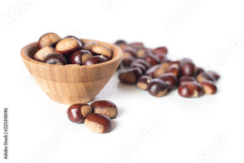 pile of chestnuts in a wooden bowl isolated 