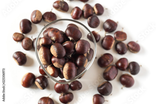 pile of chestnuts in a transparent glass bowl isolated 