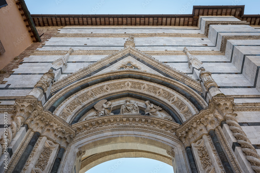 Looking up at the gateway entrance to the piazza containing Siena cathedral Looking up at the gateway entrance to the piazza containing Siena cathedral