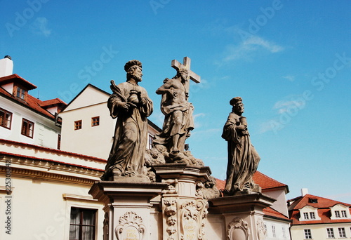 Statue of the Holy Savior with Cosmas and Damian on Charles Bridge in Prague, Czech Republic photo