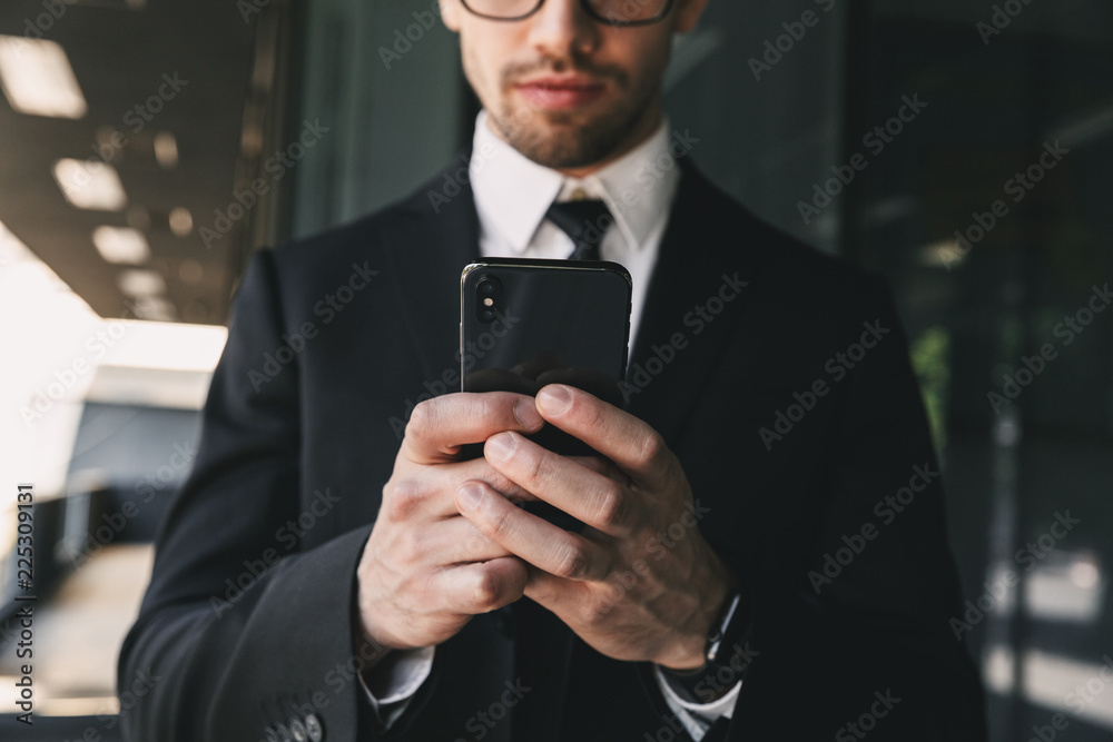 Handsome business man near business center using mobile phone. Handsome business man near business center using mobile phone.