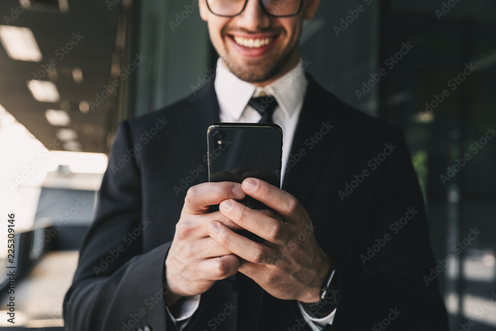 Handsome business man near business center using mobile phone. Handsome business man near business center using mobile phone.
