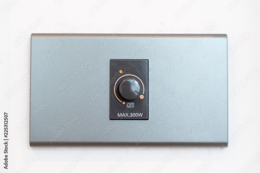 Close up hand turning on grey dimmer switch Close up hand turning on grey dimmer switch
