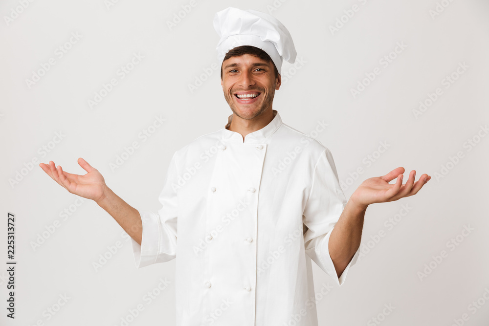 Happy young chef isolated over white background showing copyspace. Happy young chef isolated over white background showing copyspace.