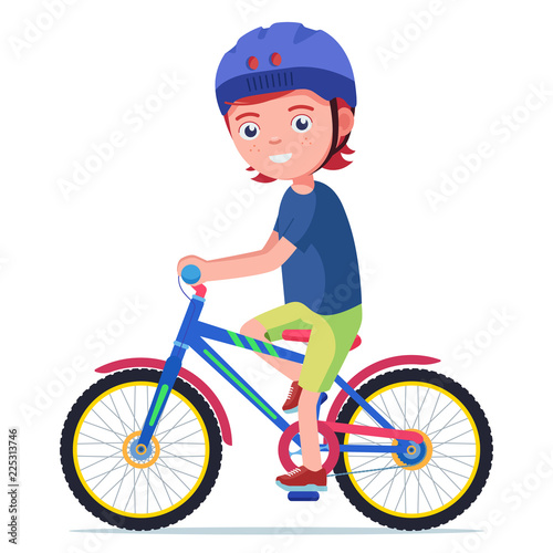 Boy rides a bicycle in a protective helmet