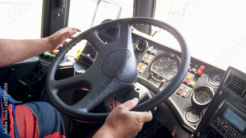 Closeup photo of man holding hands on truck steering wheel © Кирилл Рыжов
