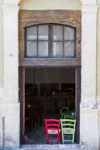 Red and green chairs at a restaurant in Siena, Tuscany