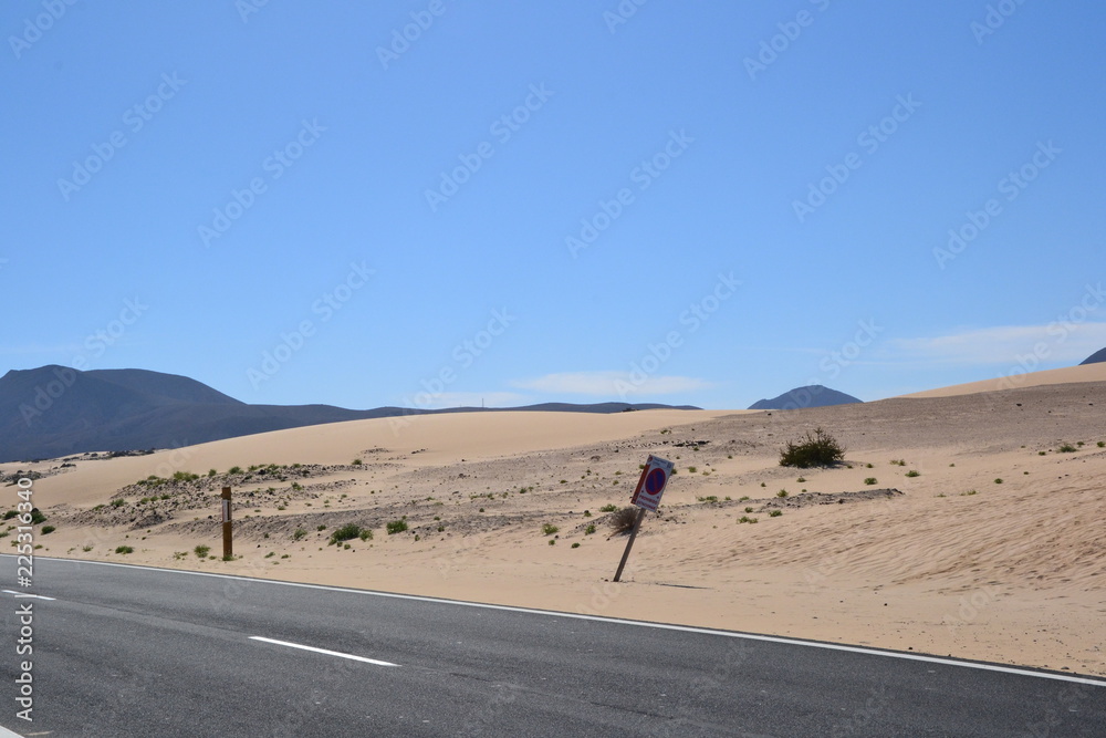 The sand dunes landscape at Parque Natural de Corralejo at Fuerteventura, Canary Islands, Spain The sand dunes landscape at Parque Natural de Corralejo at Fuerteventura, Canary Islands, Spain