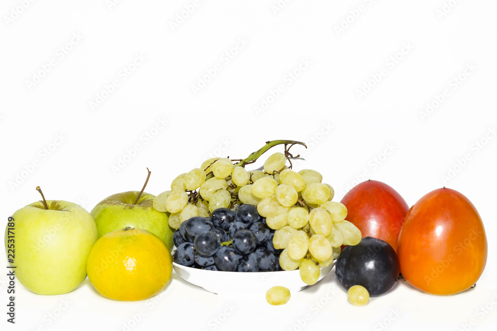 fresh grapes on a plate, persimmon, apples, plums fresh grapes on a plate, persimmon, apples, plums