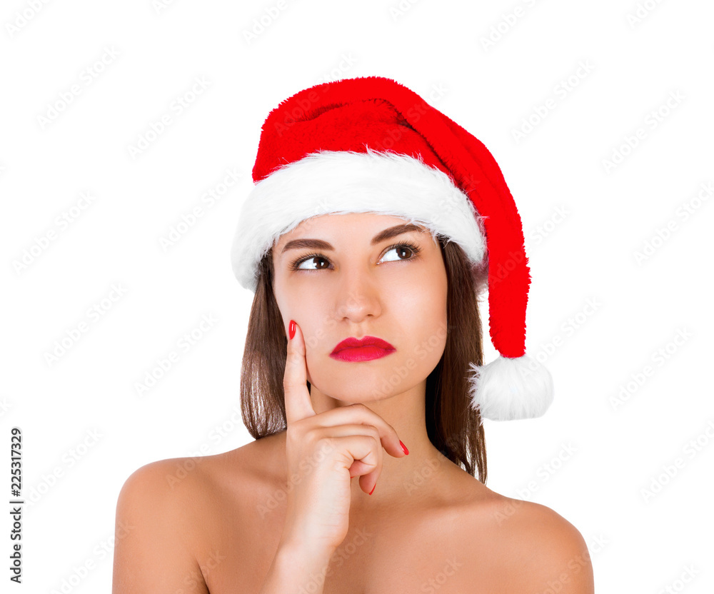portrait of thinking and reflecting girl in a Christmas hat. emotional woman in red santa claus hat isolated on white background. Happy Christmas and New Year holidays concept portrait of thinking and reflecting girl in a Christmas hat. emotional woman in red santa claus hat isolated on white background. Happy Christmas and New Year holidays concept