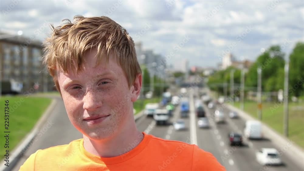 A boy against a city street background, summer, sunny day.
A boy against a city street background, summer, sunny day.