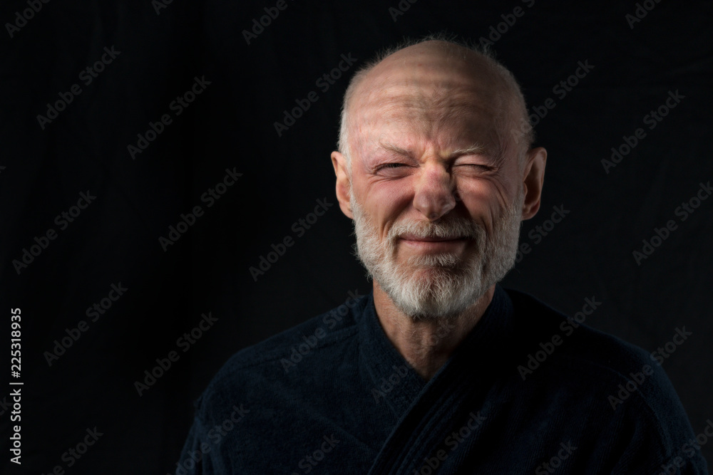 portrait of senior just awakened man in bathrobe on black background portrait of senior just awakened man in bathrobe on black background