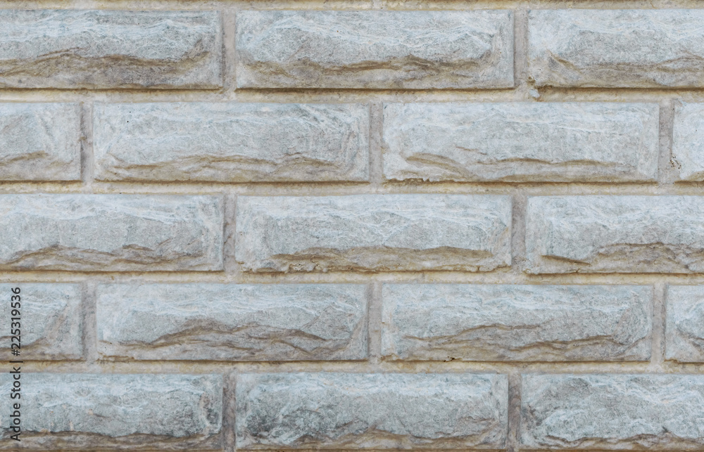 Naklejka premium Gray brick wall. Concrete fence. Textural background. Close-up.