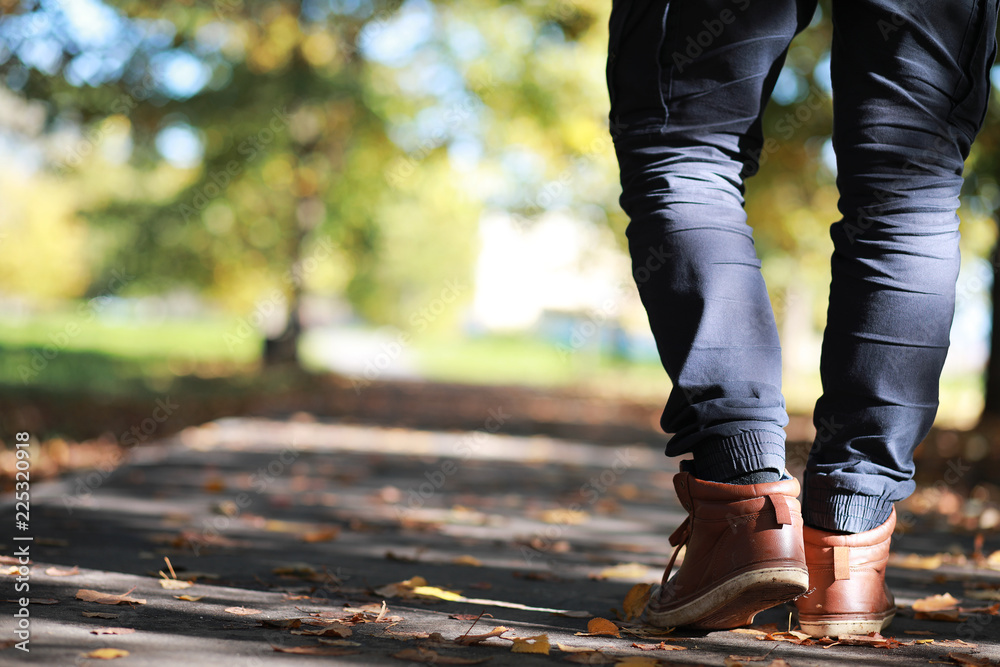 Autumn Park man walking along a path foliage Autumn Park man walking along a path foliage