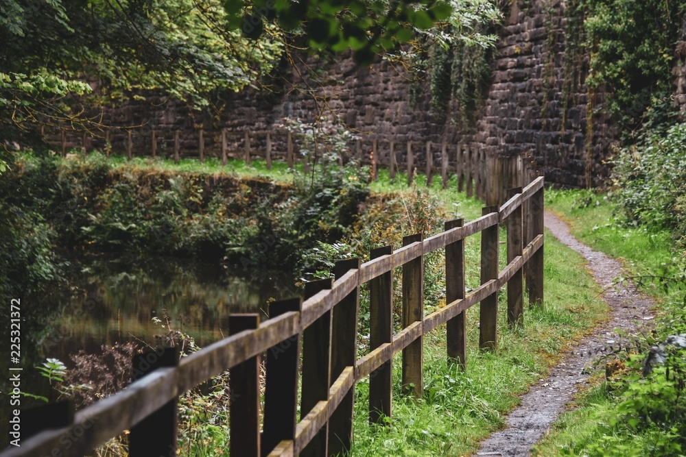 Fence and wall running by the canal Fence and wall running by the canal
