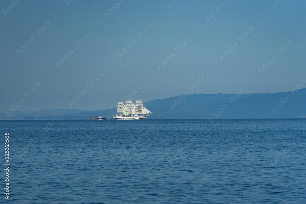 White sailboat Hope against the sea landscape