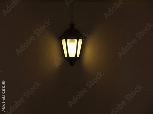 Old vintage outside lamp hanging on textured wall